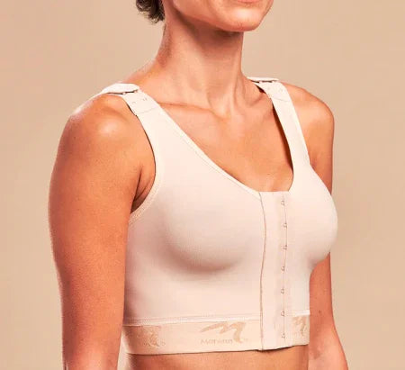 Woman wearing beige post-surgery Marena bra with front closure and adjustable straps